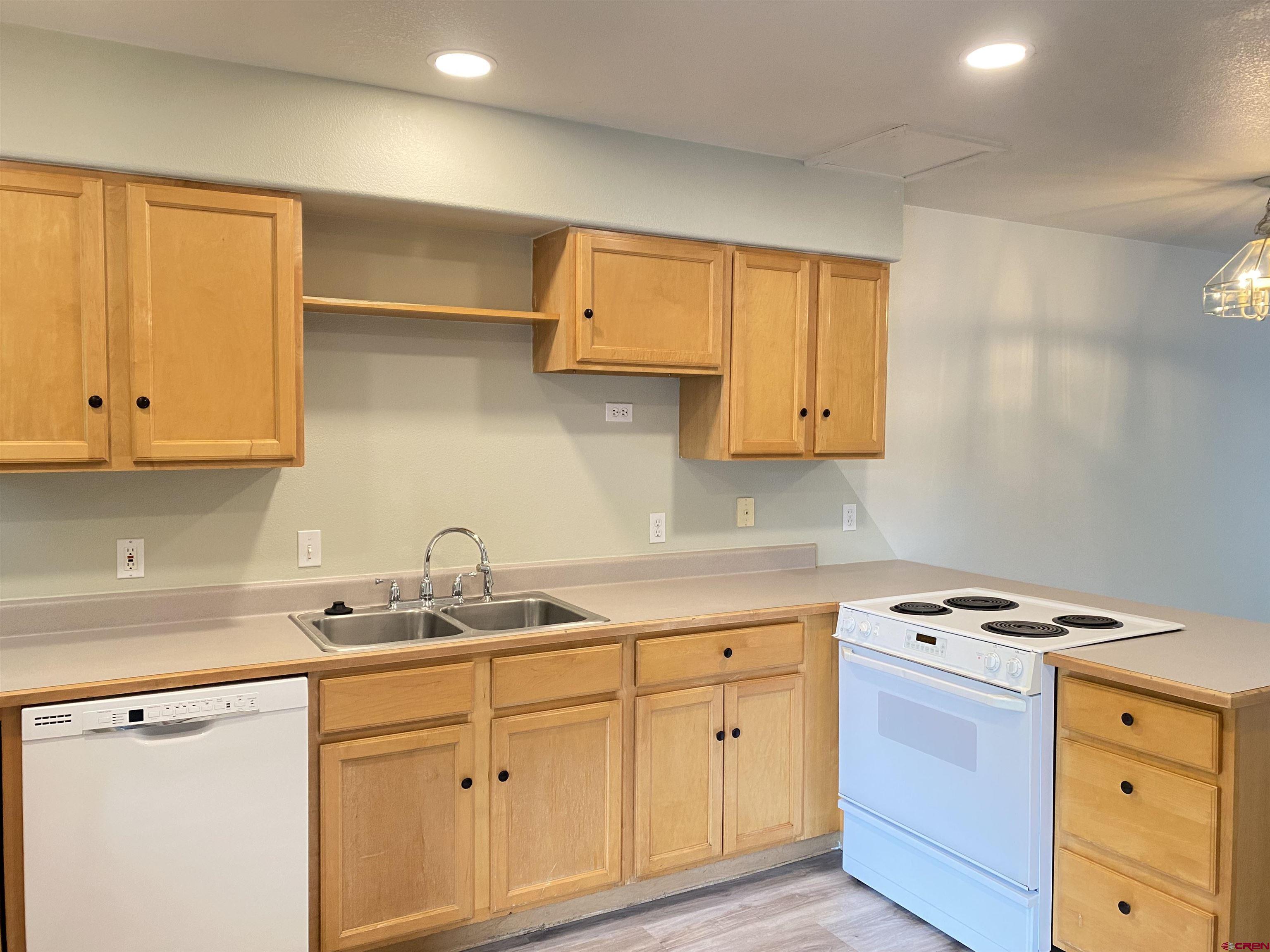 33 Sunridge Lane Durango, CO 81301 - Photo 4 of 37 a kitchen with cabinets appliances a sink and a window