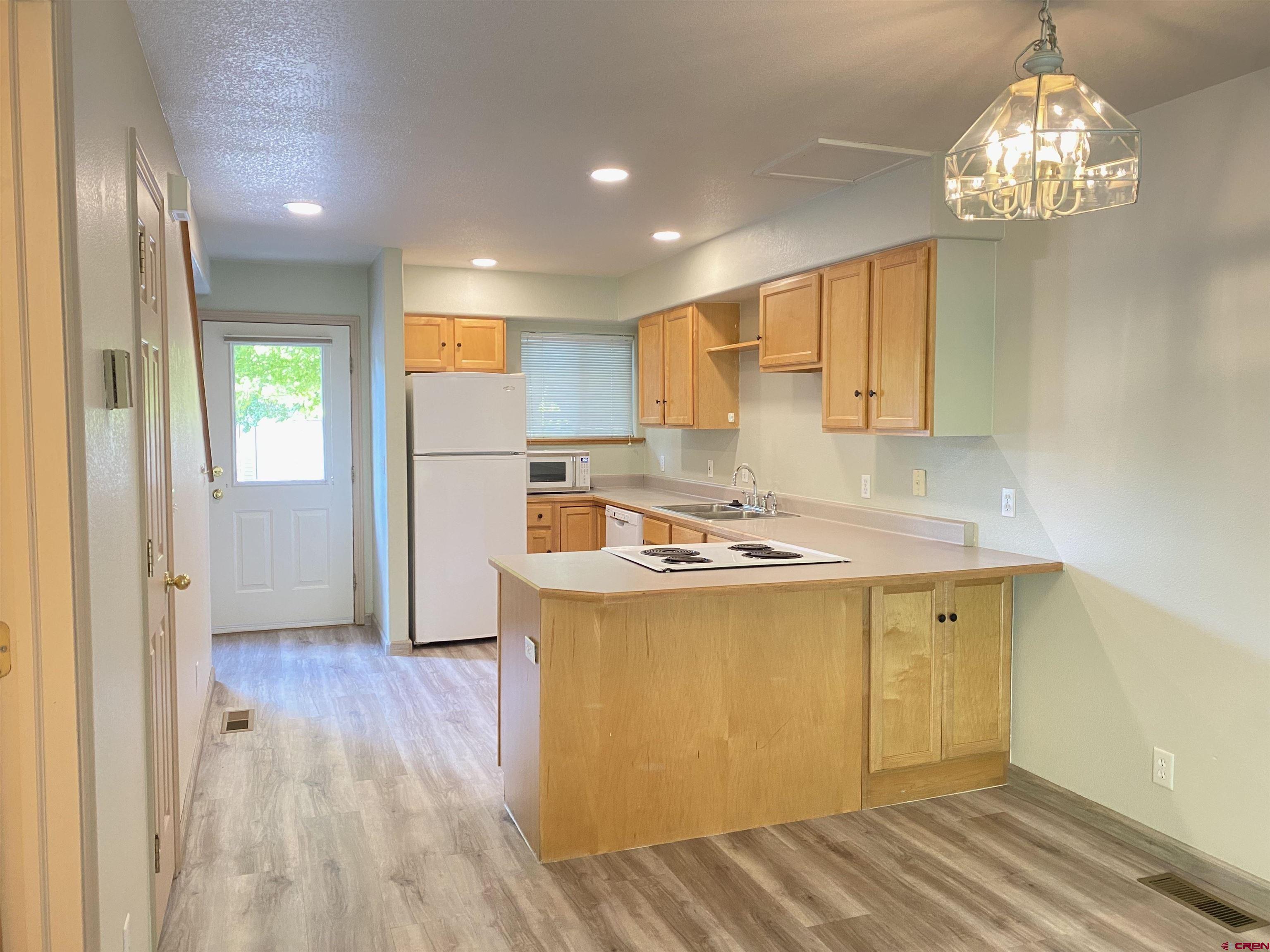 33 Sunridge Lane Durango, CO 81301 - Photo 7 of 37 a kitchen that has a lot of stainless steel appliances wooden floor and a window