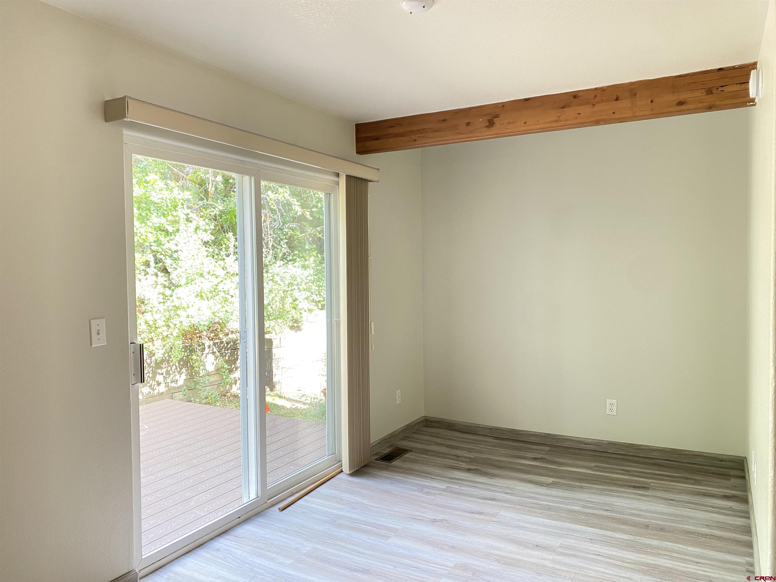 33 Sunridge Lane Durango, CO 81301 - Photo 9 of 37 a view of an empty room with wooden floor and a window