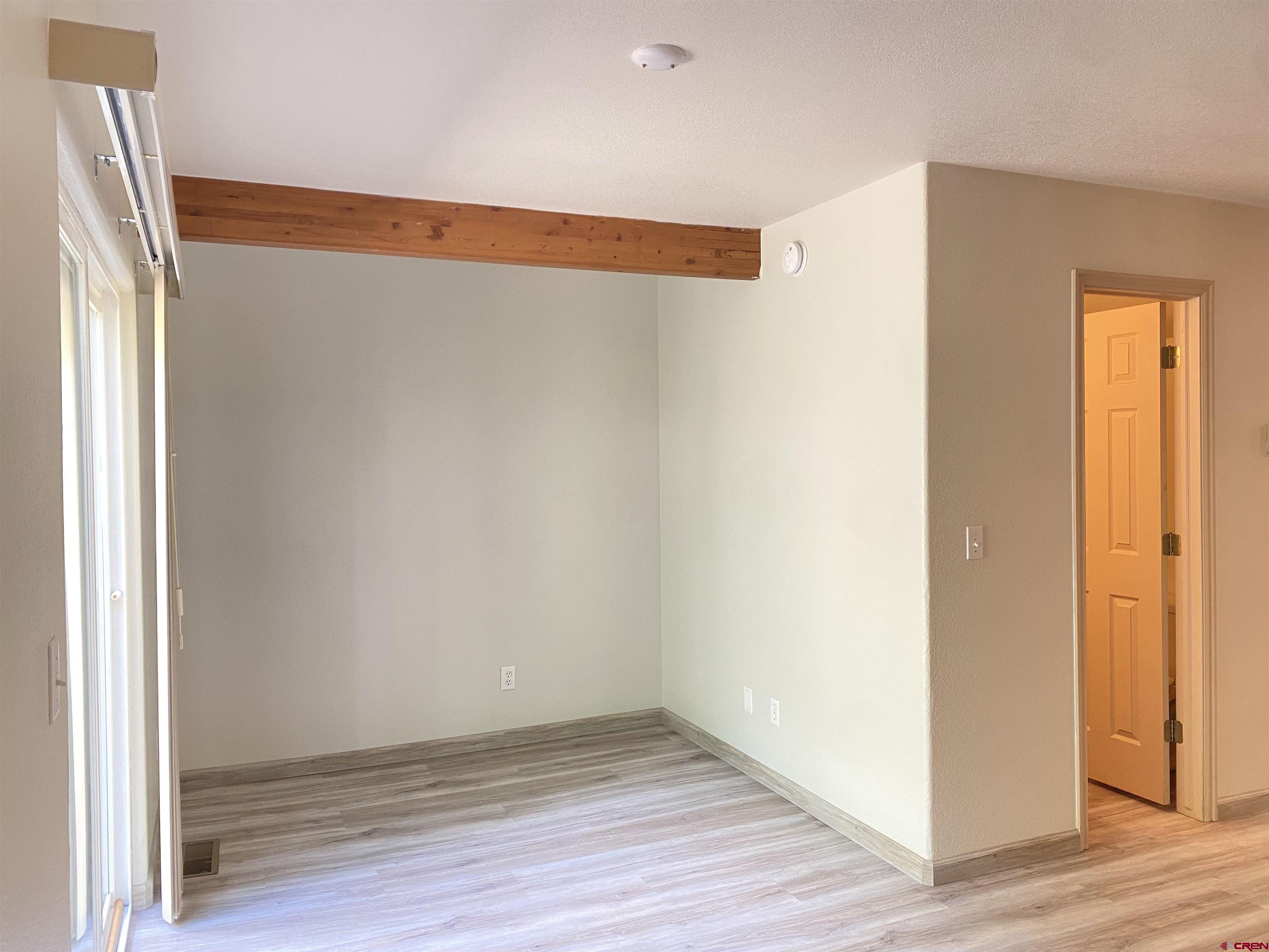 33 Sunridge Lane Durango, CO 81301 - Photo 10 of 37 a view of an empty room with wooden floor and a window