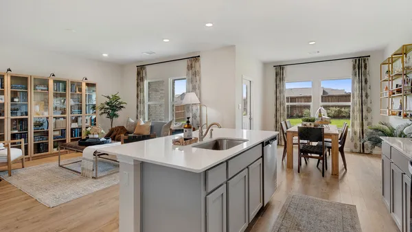 a kitchen with sink refrigerator and couches