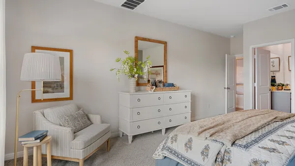 a bedroom with a bed and a couch