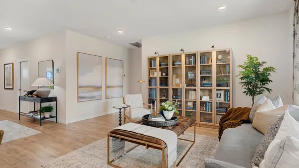 a living room with furniture and a potted plant