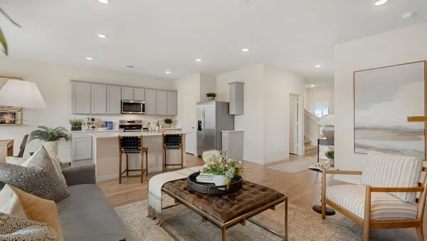 a living room with furniture and kitchen view