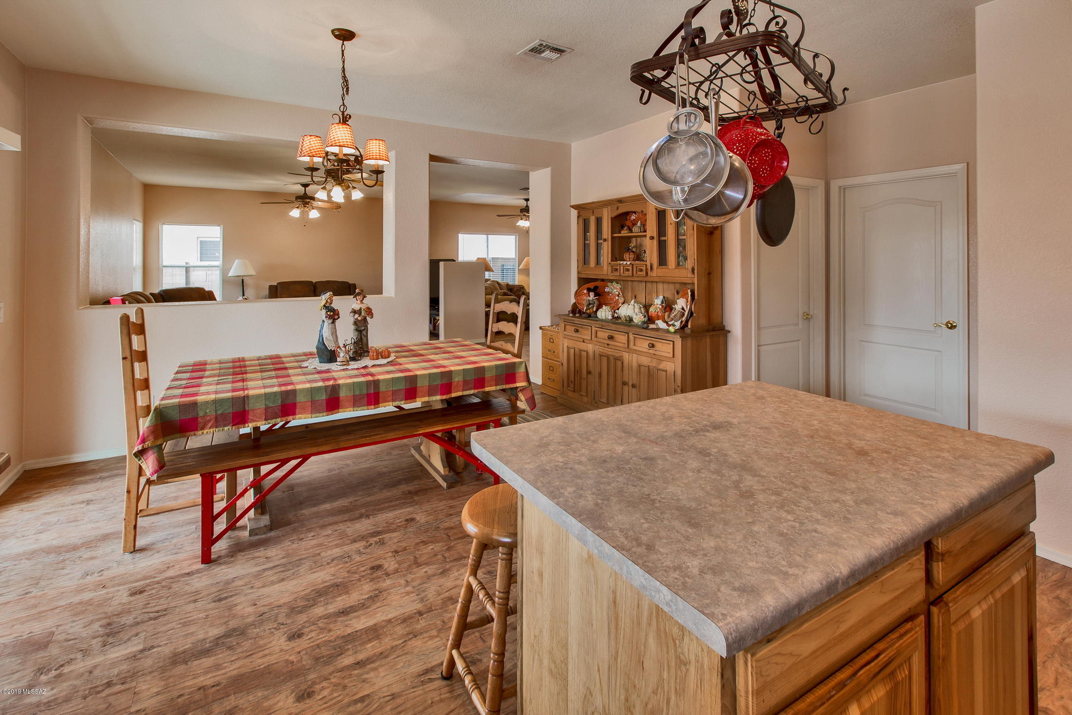 3600 East Mecate Road Tucson, AZ 85739 - Photo 13 of 39 a room with chandelier fan and wooden floor