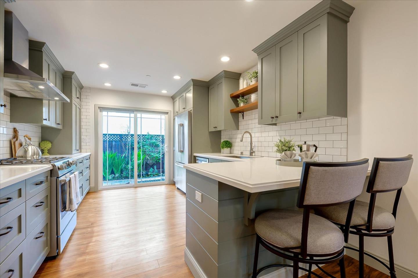 112 Haight Street Menlo Park, CA 94025 - Photo 11 of 47 a kitchen with a sink a stove cabinets dining table and chairs