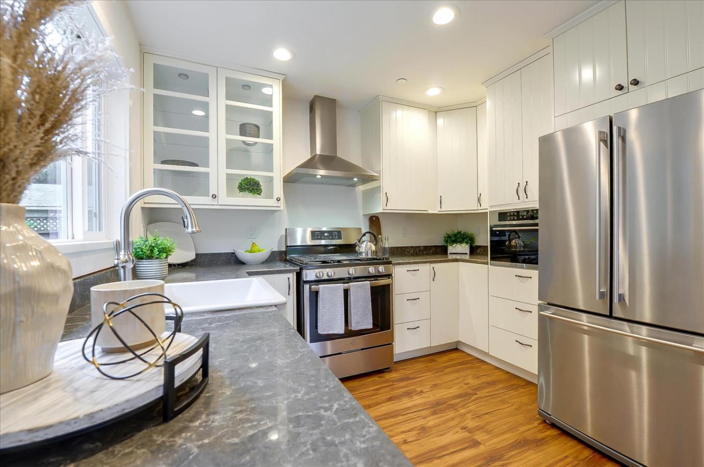 112 Haight Street Menlo Park, CA 94025 - Photo 32 of 47 a kitchen with kitchen island granite countertop a stove a sink and a refrigerator