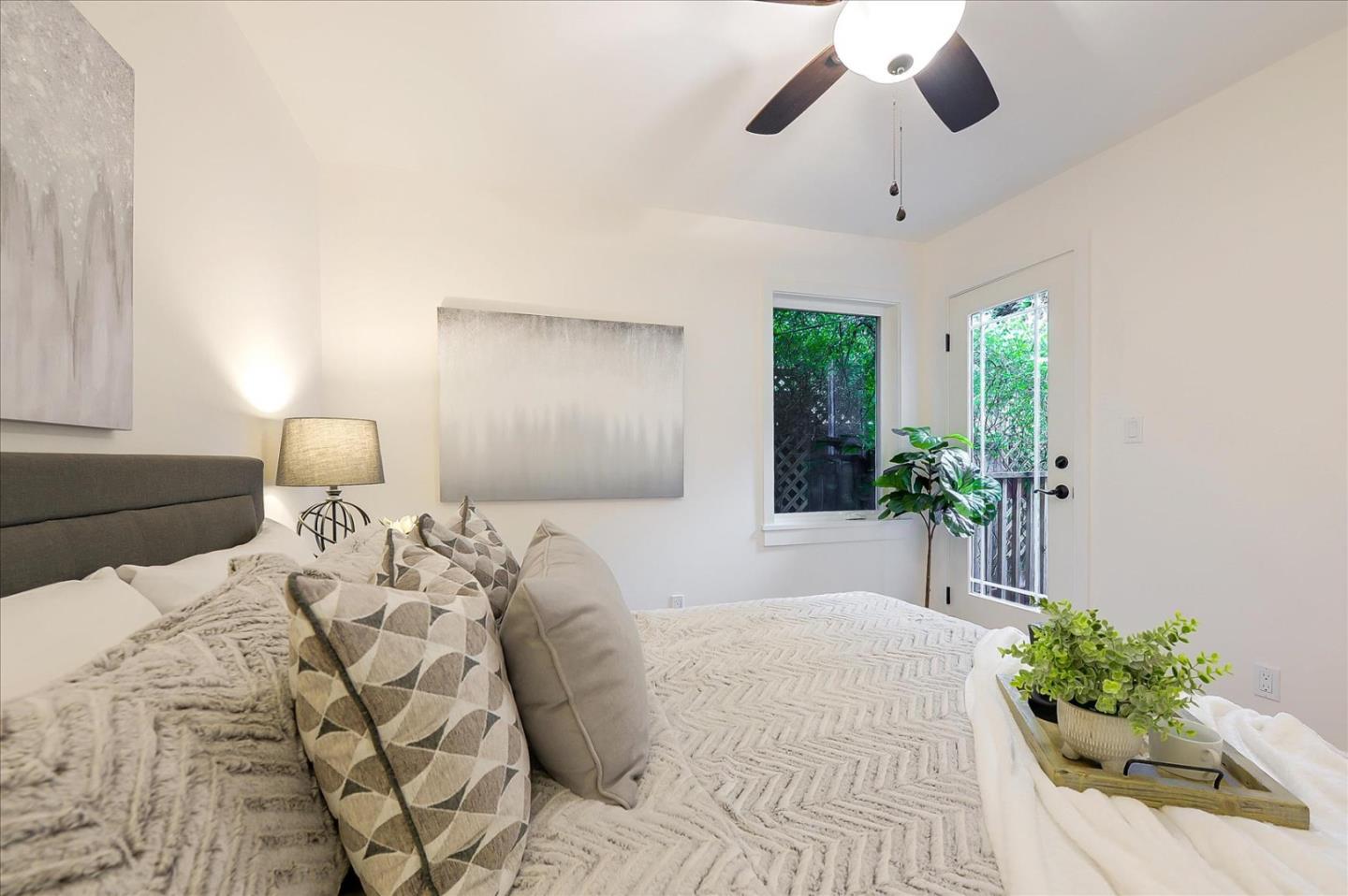 112 Haight Street Menlo Park, CA 94025 - Photo 39 of 47 a bedroom with a large bed and a chandelier