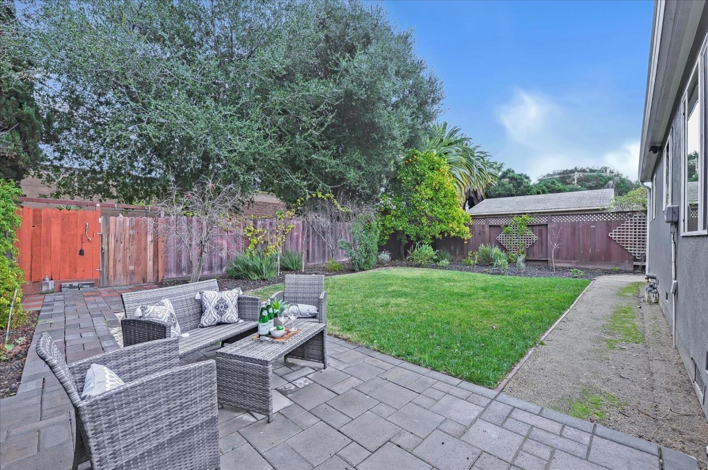 112 Haight Street Menlo Park, CA 94025 - Photo 45 of 47 a view of backyard with table and chairs and a large tree