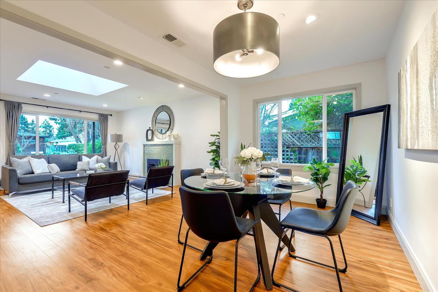112 Haight Street Menlo Park, CA 94025 - Photo 9 of 47 a dining room with furniture a large window and a chandelier