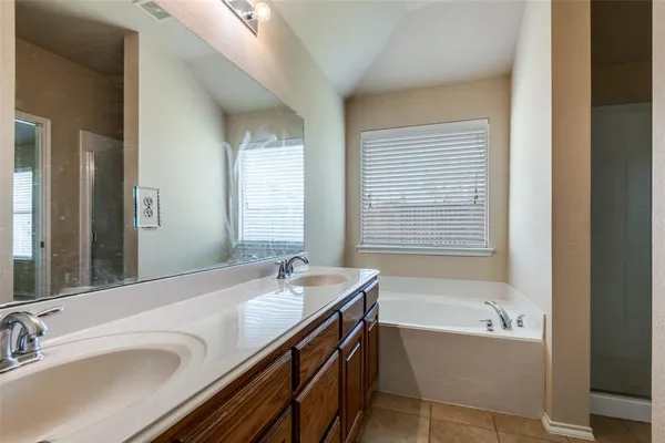 a bathroom with a bathtub and a sink
