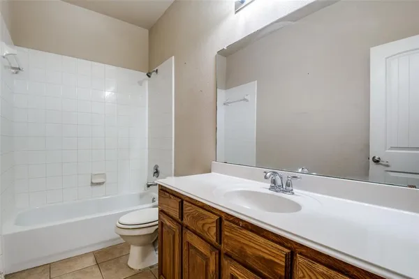 a bathroom with a sink toilet a vanity and bathtub