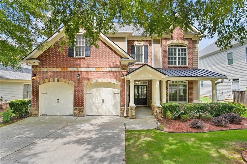 a view of a white house with a small yard and large tree