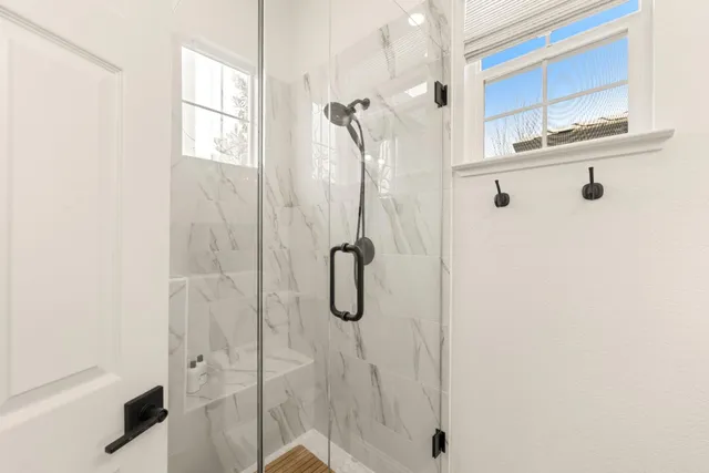 a dining room with furniture a chandelier and wooden floor