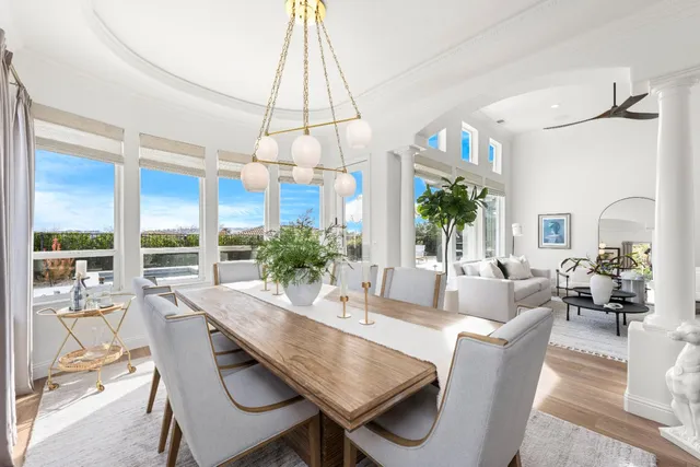 a view of a hallway with wooden floor and a windows