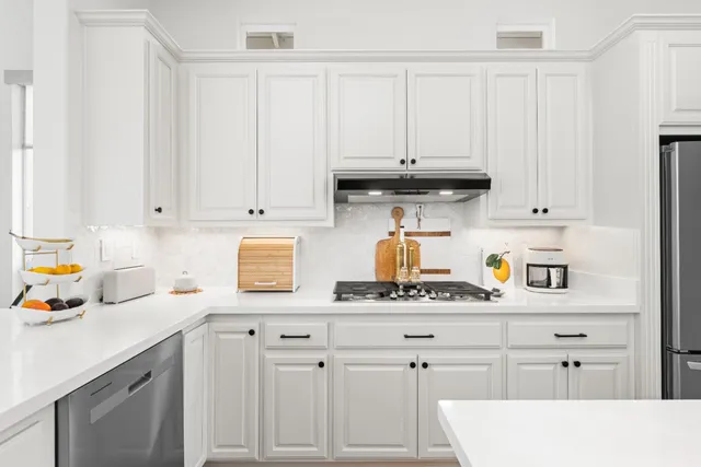 a spacious bedroom with a bed and a flat screen tv