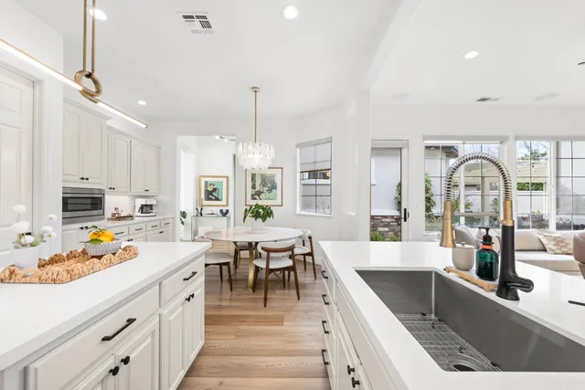 a spacious bedroom with a bed and a chandelier