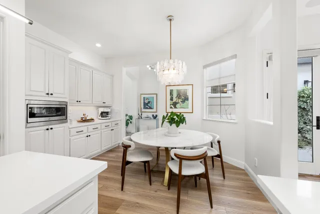a view of a patio with a table and chairs under an umbrella