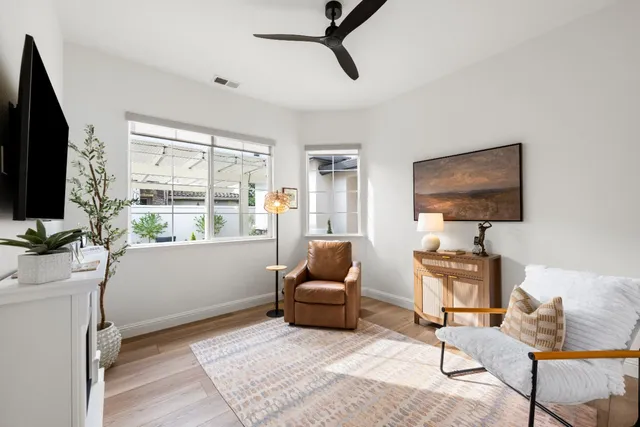 an aerial view of a city with lots of residential buildings ocean and mountain view in back