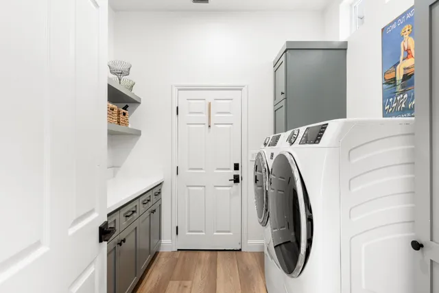 front view of a house with a yard and potted plants