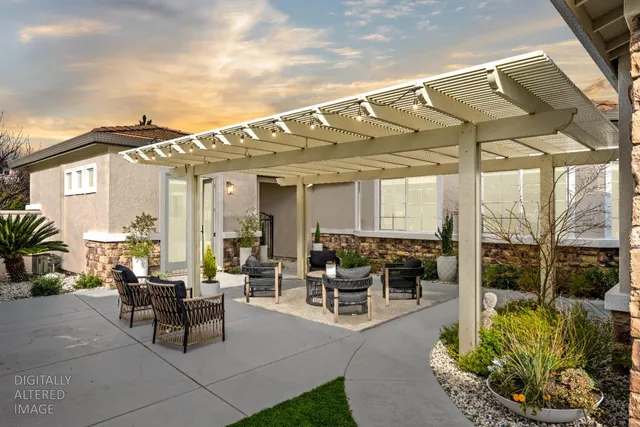 a view of a patio with couches and table and chairs and potted plants