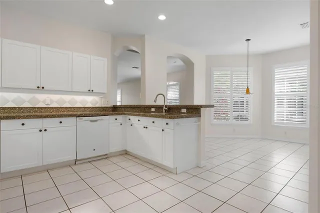 a bedroom with a bed and painting on the wall