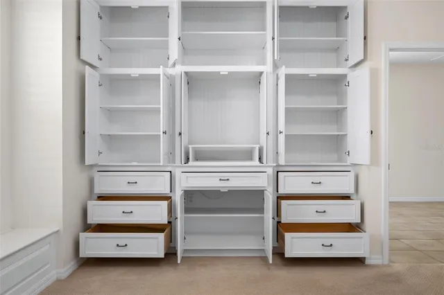 an aerial view of residential houses with outdoor space and trees