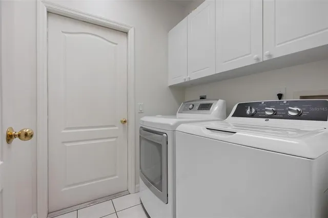 a front view of multi story residential apartment building with yellow lighting