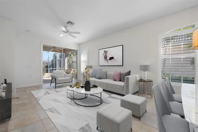 a living room with furniture a flat screen tv and a large window