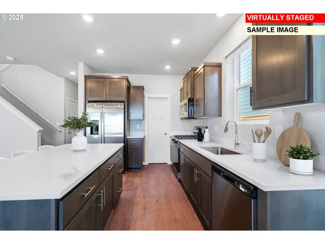 a kitchen with stainless steel appliances granite countertop a sink a stove and cabinets