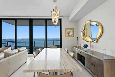 a view of a dining room with furniture a chandelier and wooden floor
