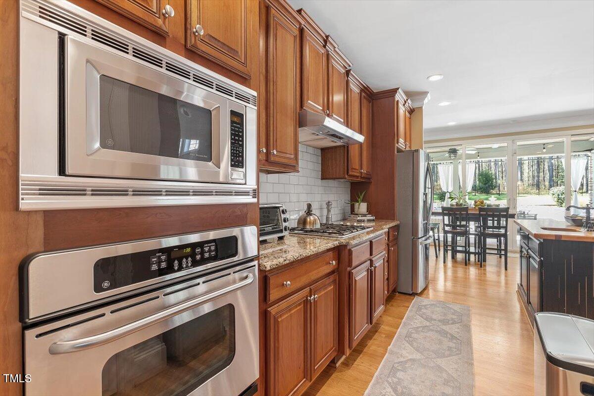 3504 Griffice Mill Road Raleigh, NC 27610 - Photo 11 of 39 a kitchen with a stove microwave and cabinets