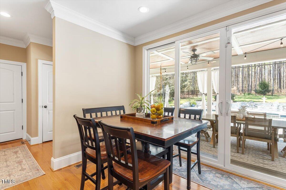 3504 Griffice Mill Road Raleigh, NC 27610 - Photo 12 of 39 a view of a dining room with furniture and wooden floor