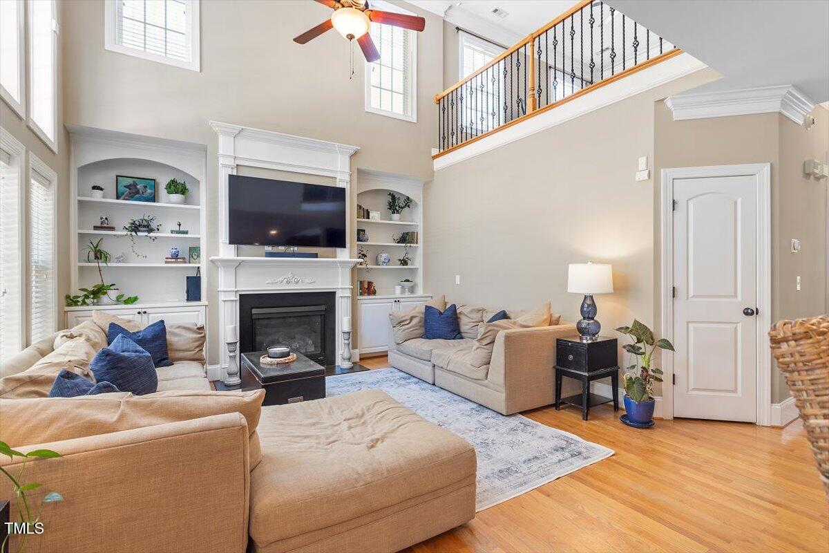 3504 Griffice Mill Road Raleigh, NC 27610 - Photo 13 of 39 a living room with furniture a flat screen tv and a fireplace