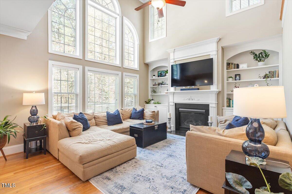 3504 Griffice Mill Road Raleigh, NC 27610 - Photo 14 of 39 a living room with furniture a fireplace and a flat screen tv