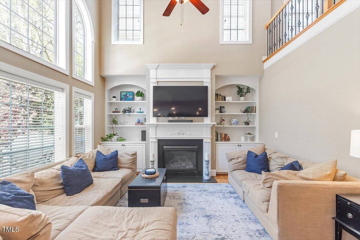 3504 Griffice Mill Road Raleigh, NC 27610 - Photo 15 of 39 a living room with furniture a window and a fireplace