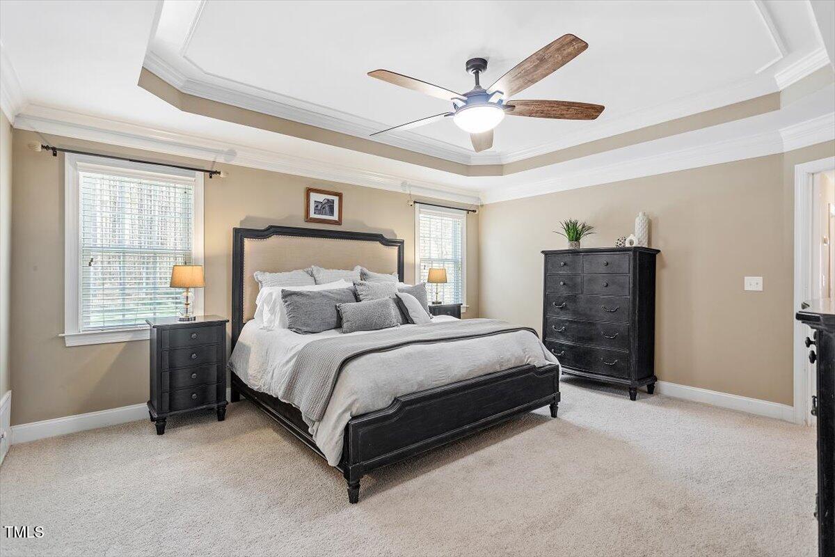 3504 Griffice Mill Road Raleigh, NC 27610 - Photo 18 of 39 a spacious bedroom with a bed and a ceiling fan