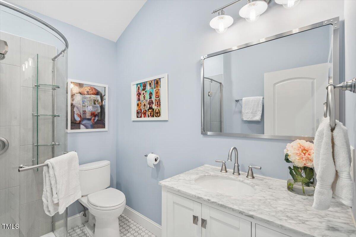 3504 Griffice Mill Road Raleigh, NC 27610 - Photo 28 of 39 a bathroom with a granite countertop sink mirror vanity and toilet