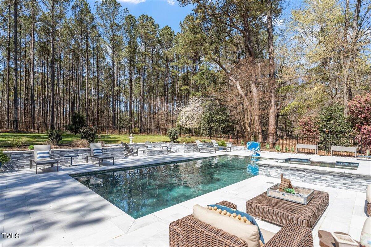 3504 Griffice Mill Road Raleigh, NC 27610 - Photo 33 of 39 a view of a swimming pool with lounge chairs in patio