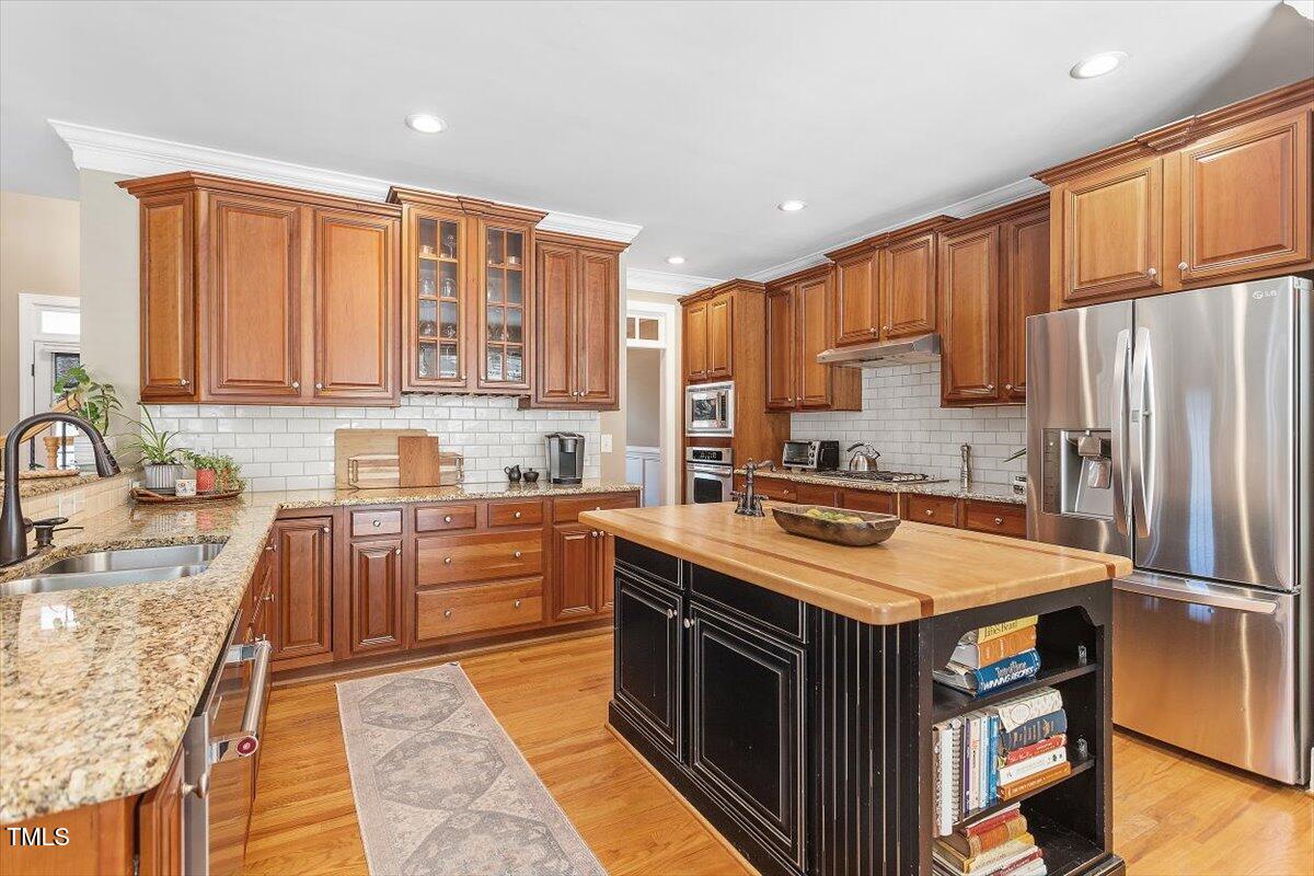 3504 Griffice Mill Road Raleigh, NC 27610 - Photo 9 of 39 a kitchen with stainless steel appliances granite countertop a sink stove and refrigerator