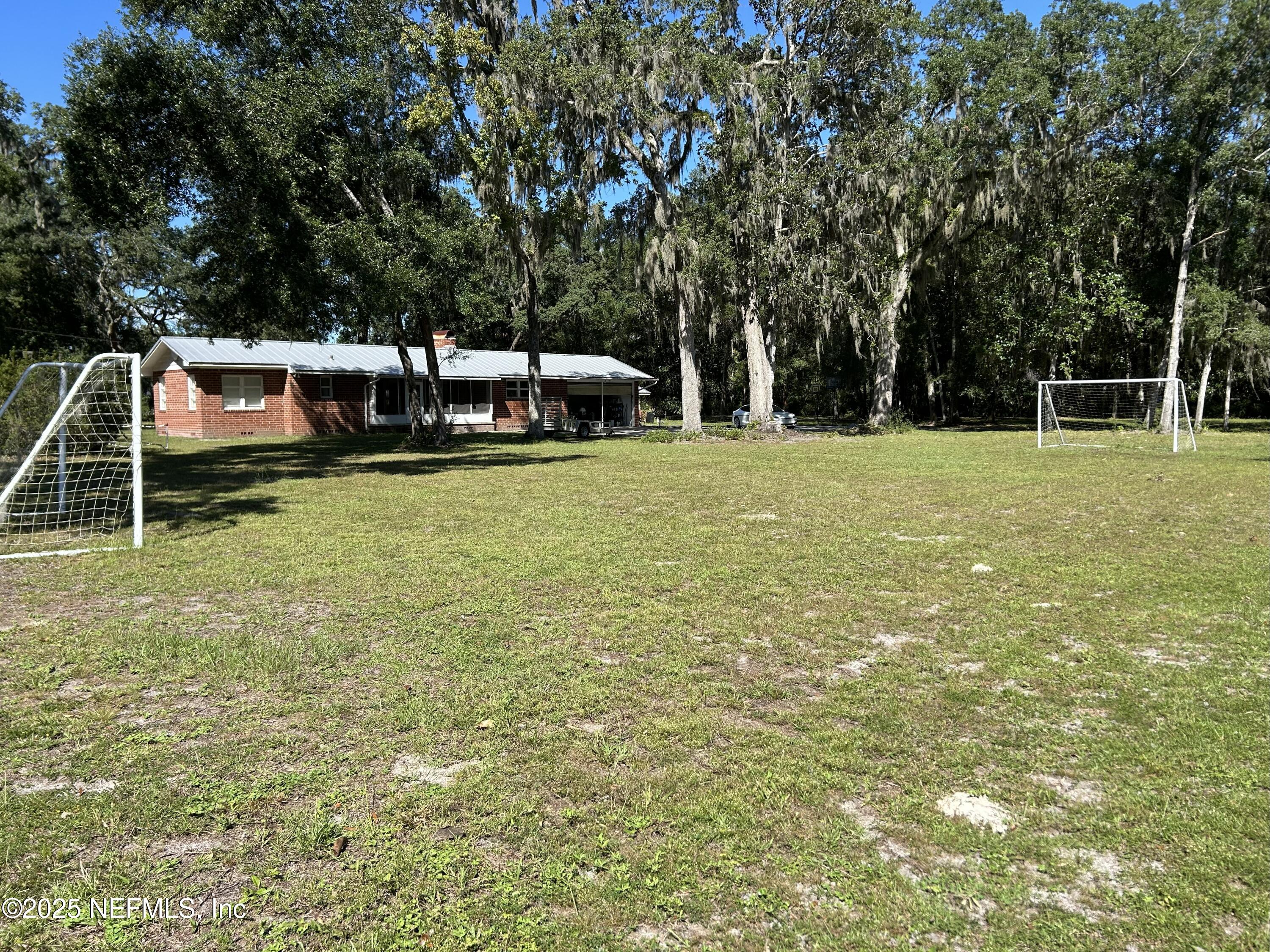 940 Myron Road Jacksonville, FL 32259 - Photo 12 of 20 a backyard of a house with table and chairs