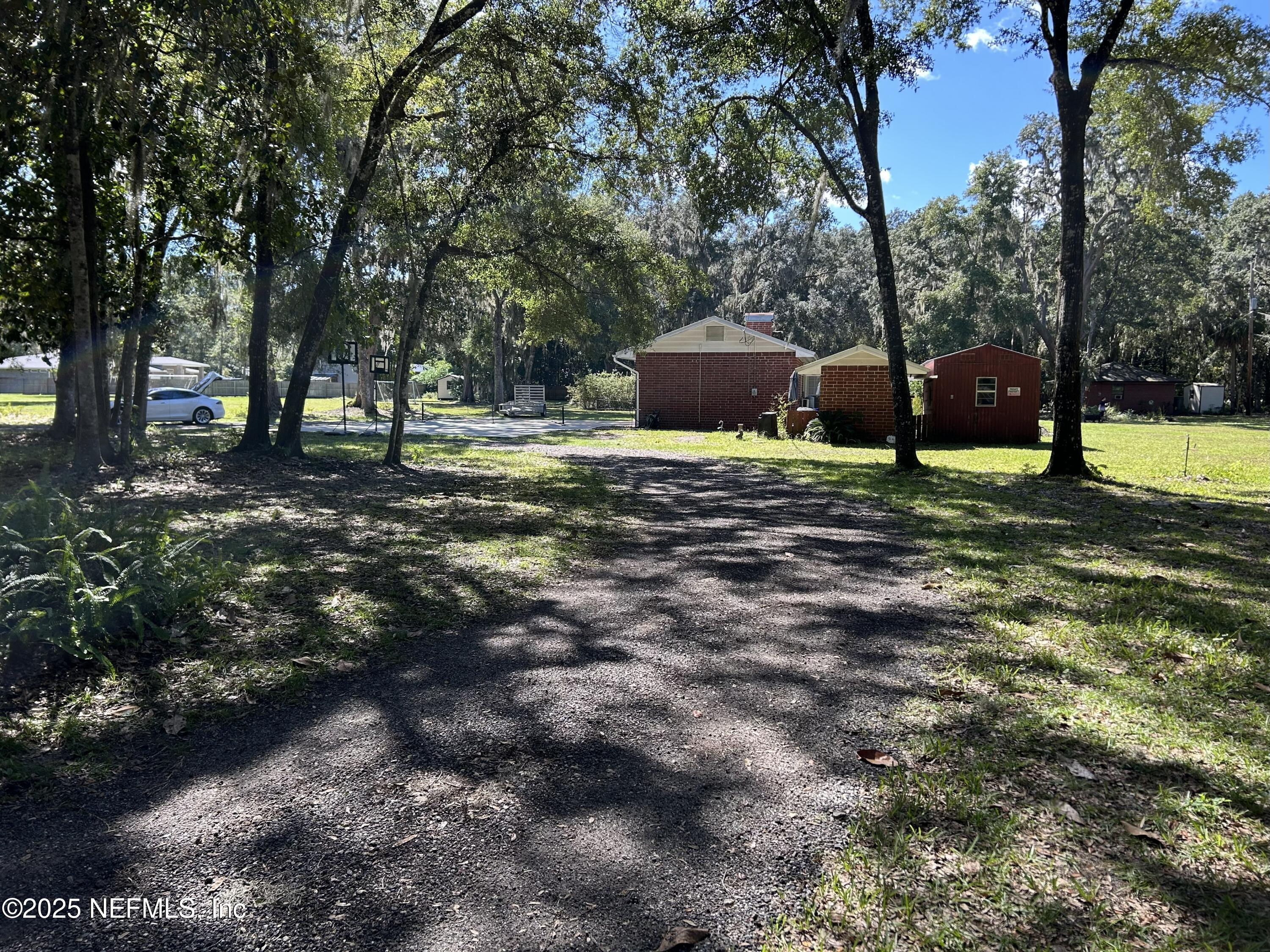 940 Myron Road Jacksonville, FL 32259 - Photo 18 of 20 a backyard of a house with barbeque oven table and chairs
