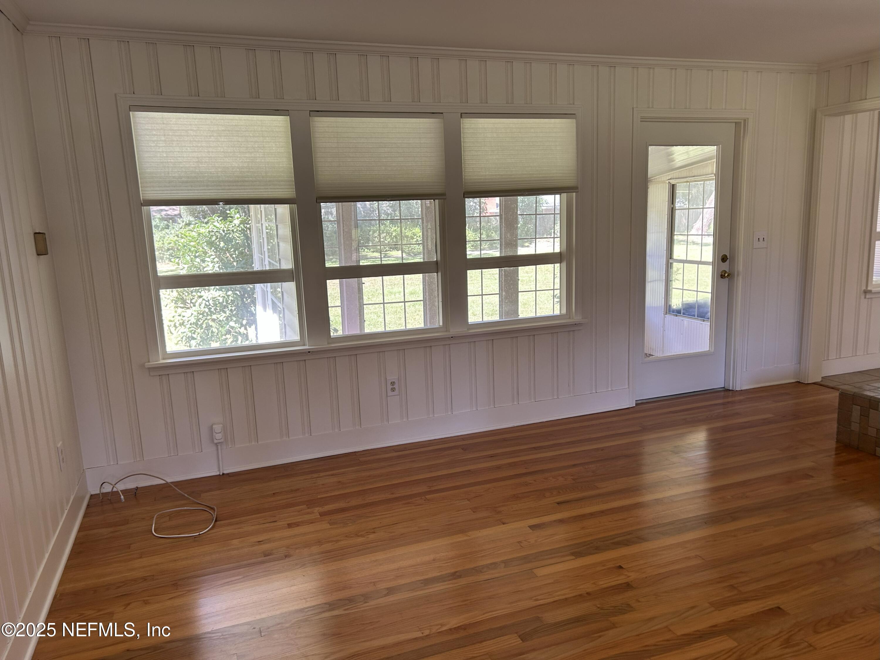 940 Myron Road Jacksonville, FL 32259 - Photo 3 of 20 a view of an empty room with wooden floor and a window