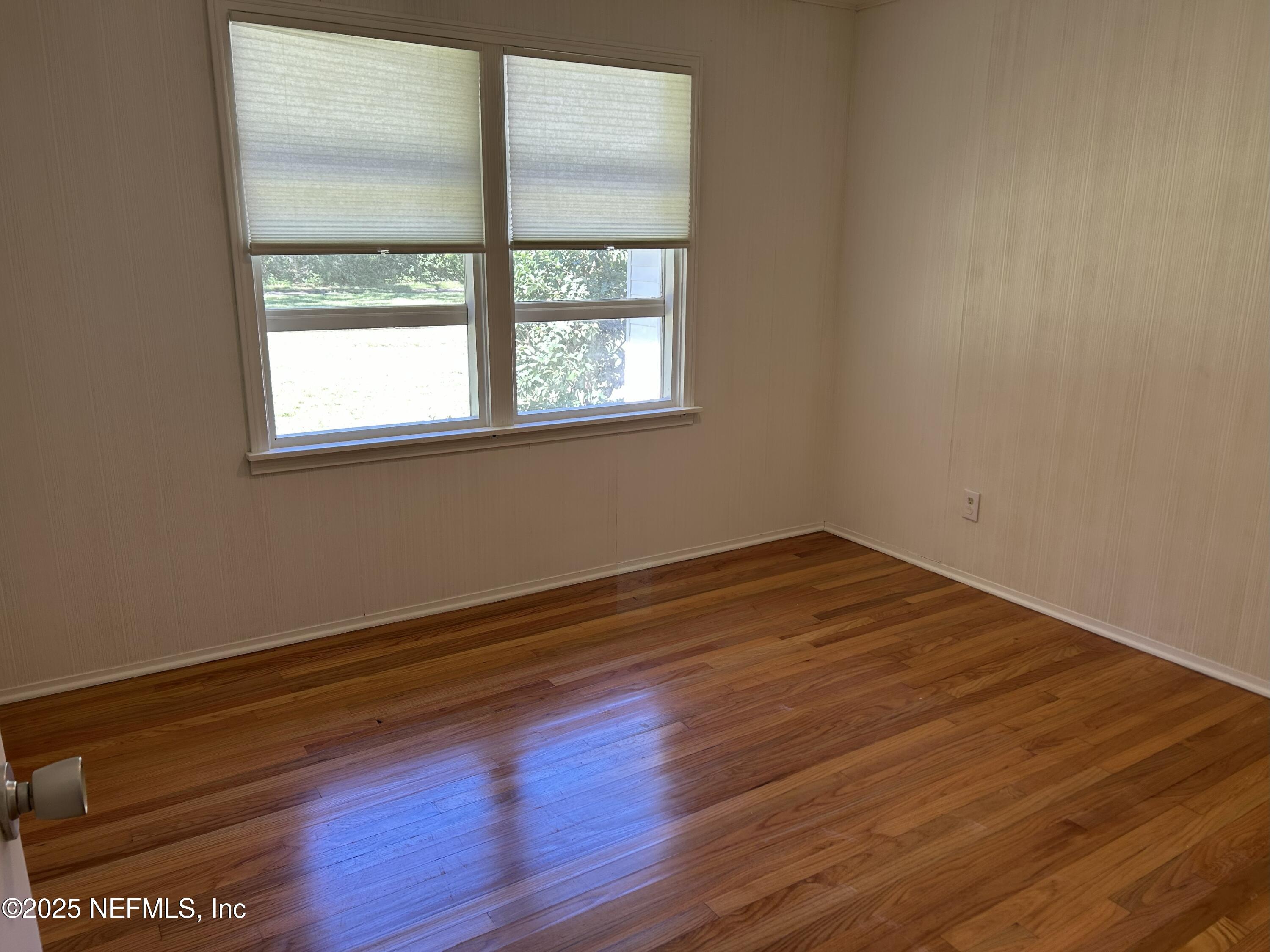 940 Myron Road Jacksonville, FL 32259 - Photo 4 of 20 an empty room with wooden floor and windows