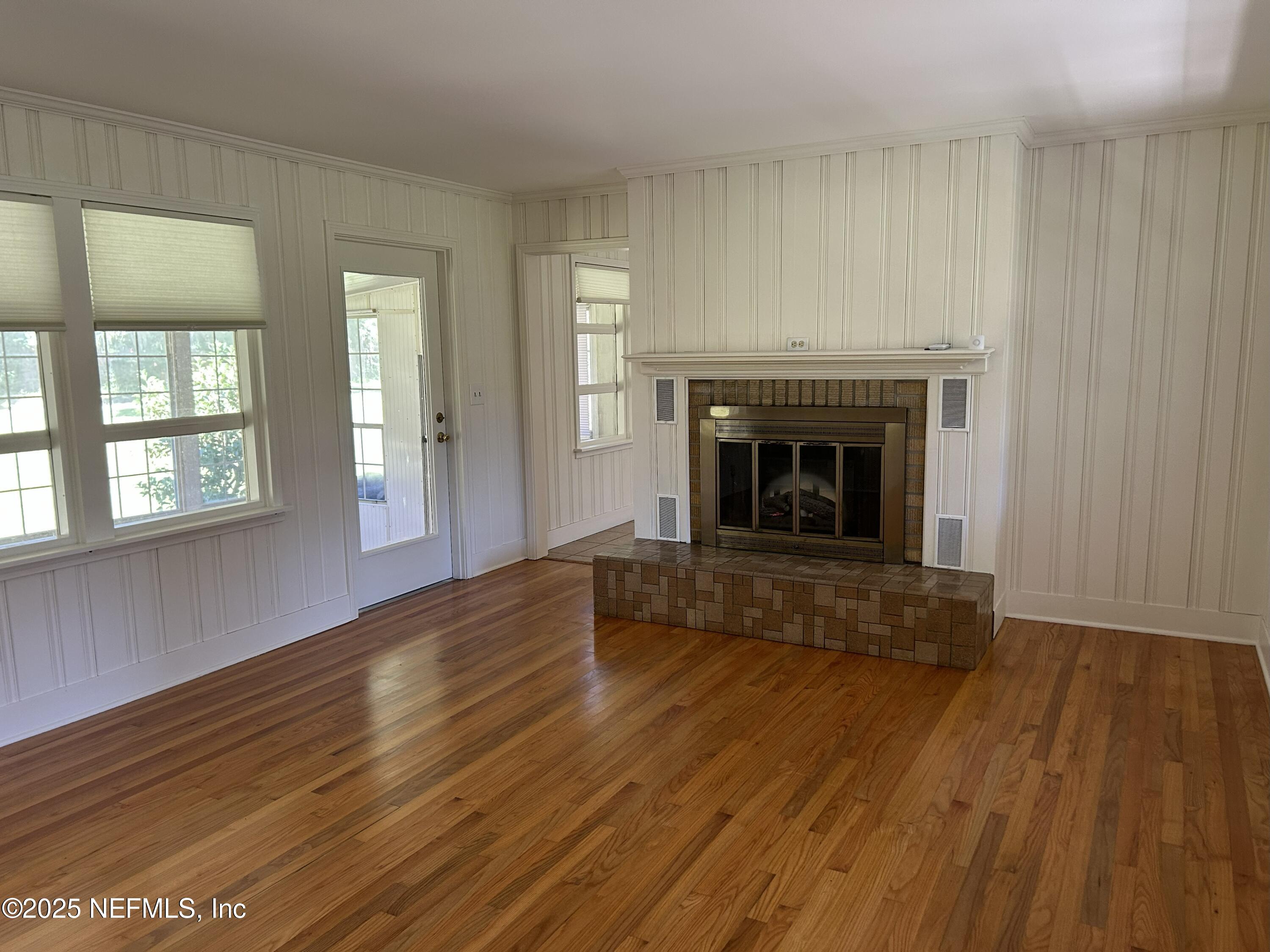 940 Myron Road Jacksonville, FL 32259 - Photo 5 of 20 a view of an empty room with wooden floor fireplace and a window