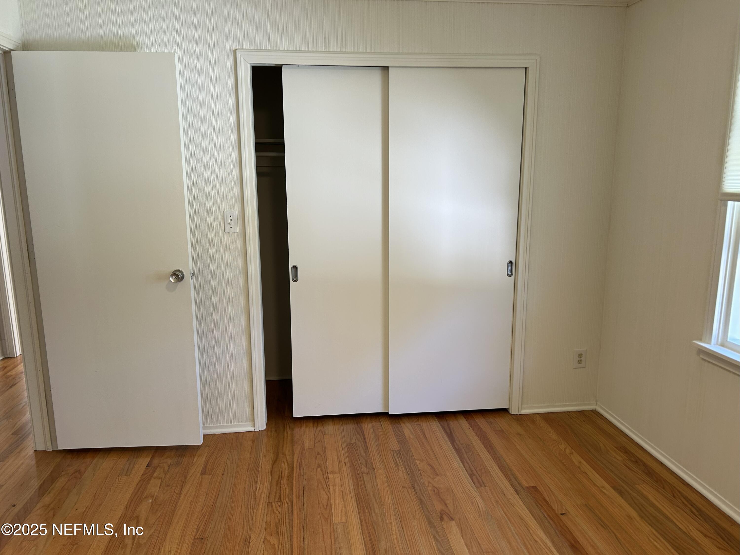 940 Myron Road Jacksonville, FL 32259 - Photo 7 of 20 a view of an empty room with wooden floor and a window