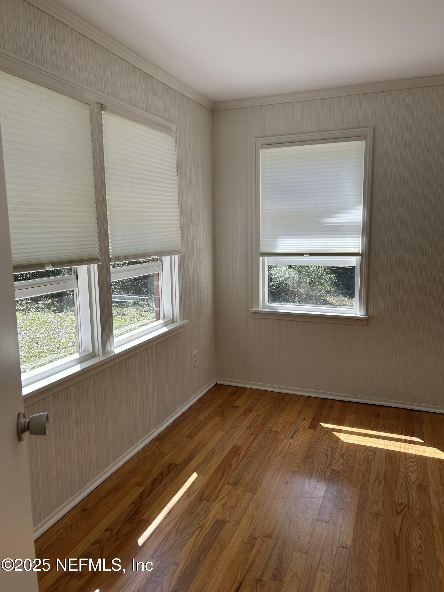 940 Myron Road Jacksonville, FL 32259 - Photo 9 of 20 a view of an empty room with wooden floor and a window