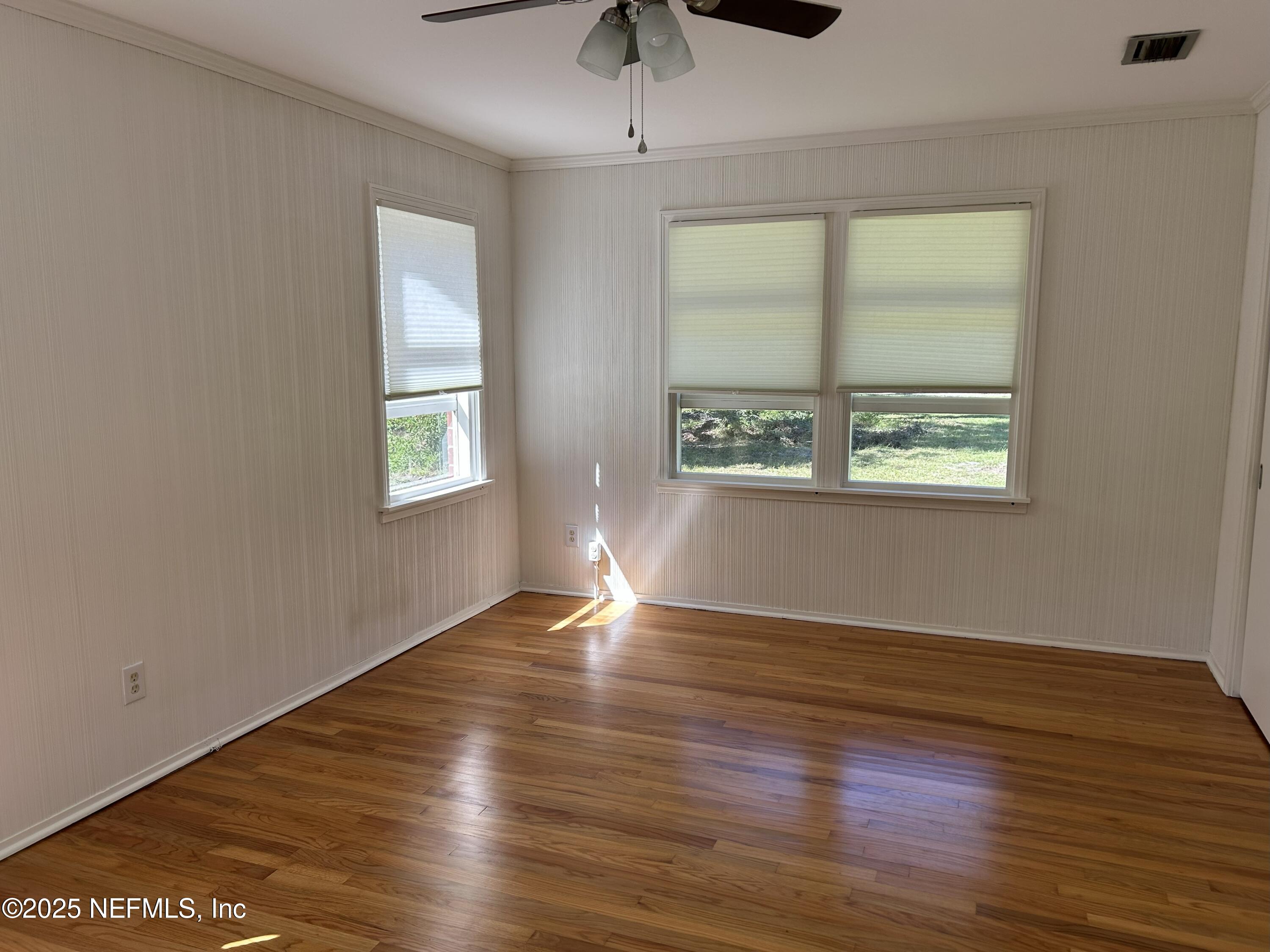 940 Myron Road Jacksonville, FL 32259 - Photo 10 of 20 a view of an empty room with wooden floor and a window