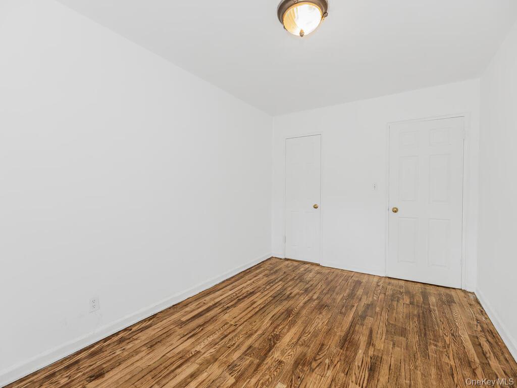 144 Ravine Avenue, Unit 2C Yonkers, NY 10701 - Photo 9 of 15 Unfurnished room featuring hardwood / wood-style floors