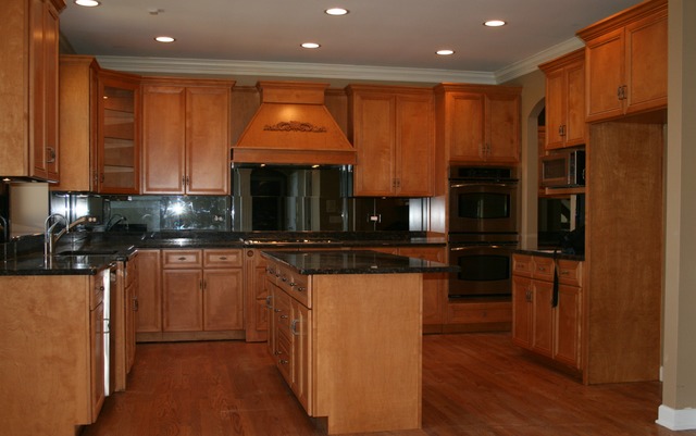 4115 Champion Road Naperville, IL 60564 - Photo 7 of 18 a kitchen with stainless steel appliances granite countertop a refrigerator a oven a sink with wooden cabinets and wooden floor